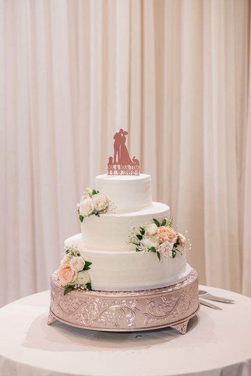 wedding cake with custom topper featuring two rabbits