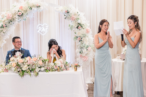 bridesmaids giving a touching and emotional speech while bride wipes away a tear