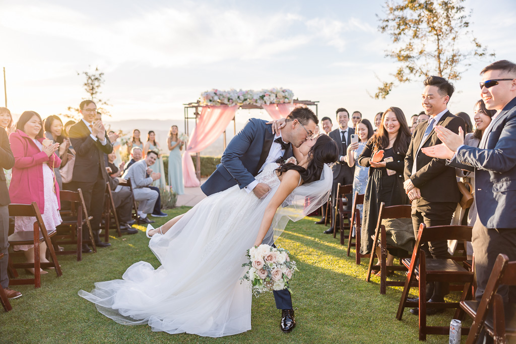 dip and kiss at the end of the aisle