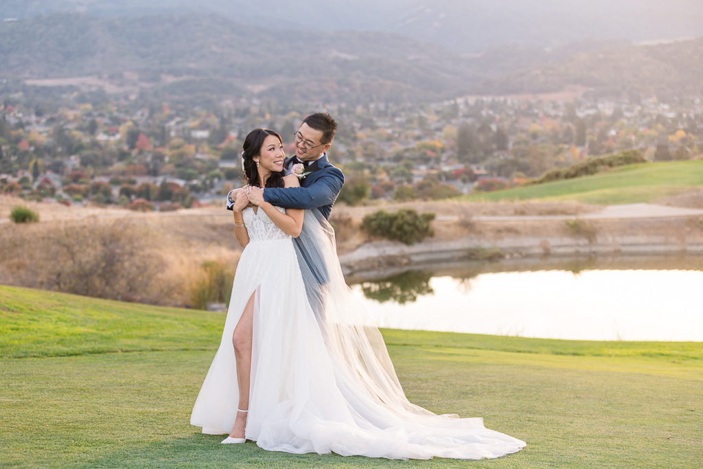 wedding portrait in front of a pond at sunset