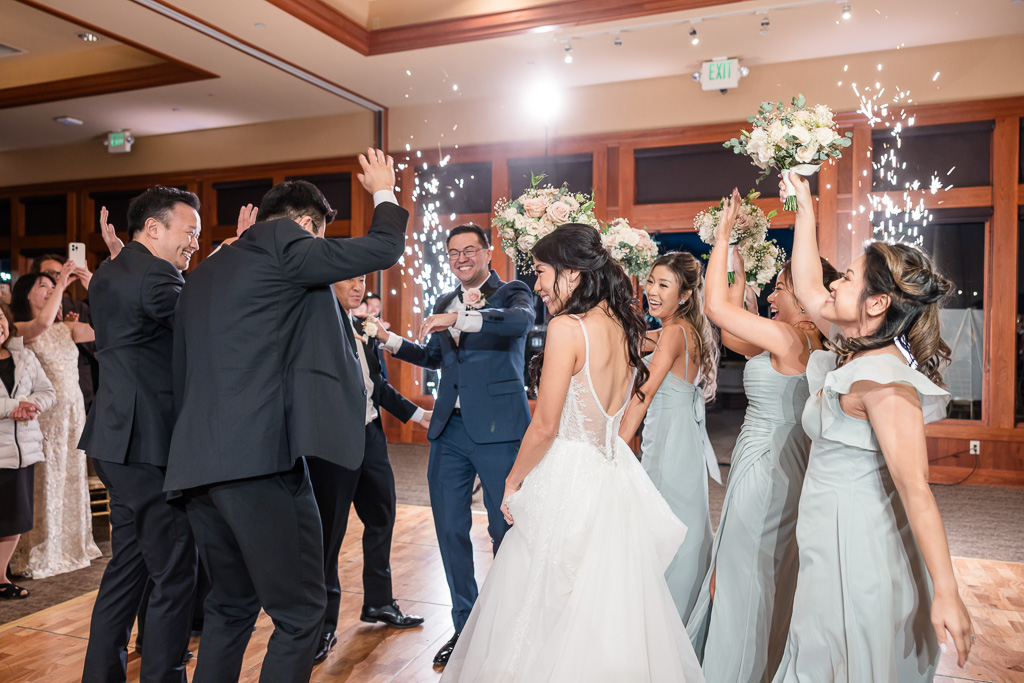 bride and groom dancing with bridal party during grand entrance