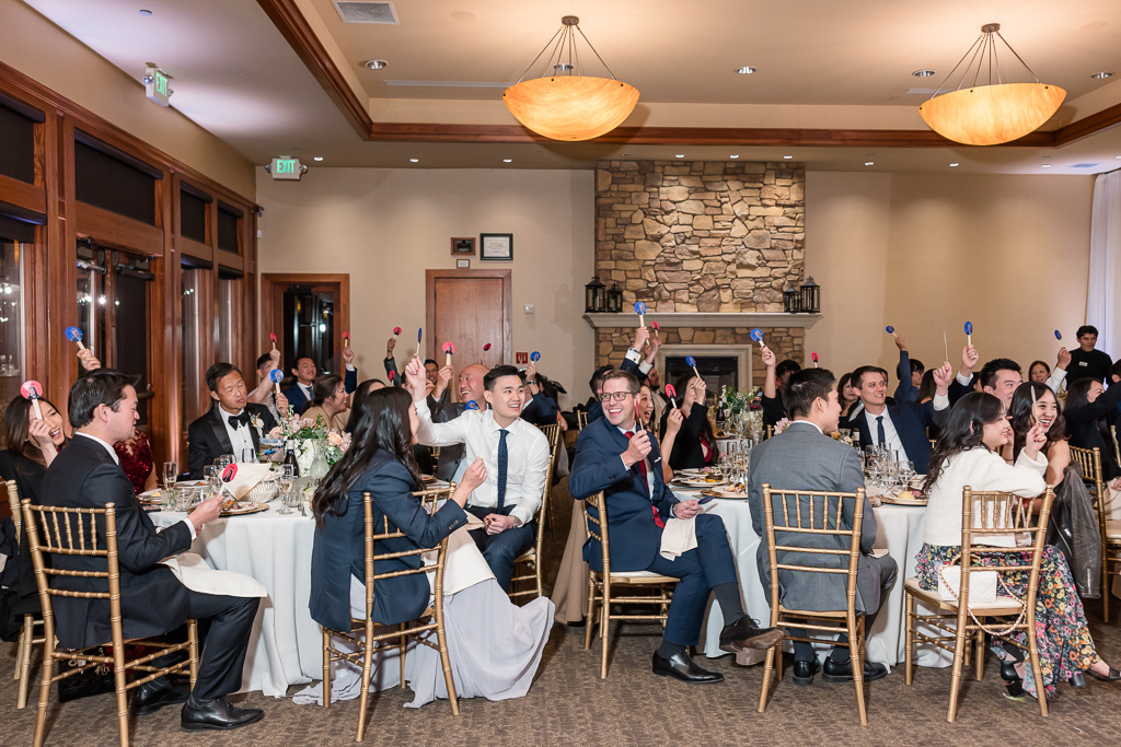 wedding guests voting for the bride and groom