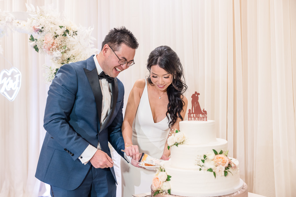 bride and groom cutting Wedgewood cake