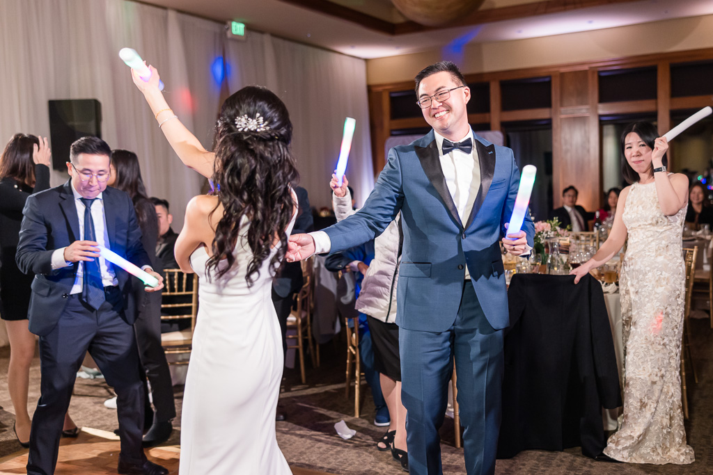 groom giving the bride a twirl on the dance floor