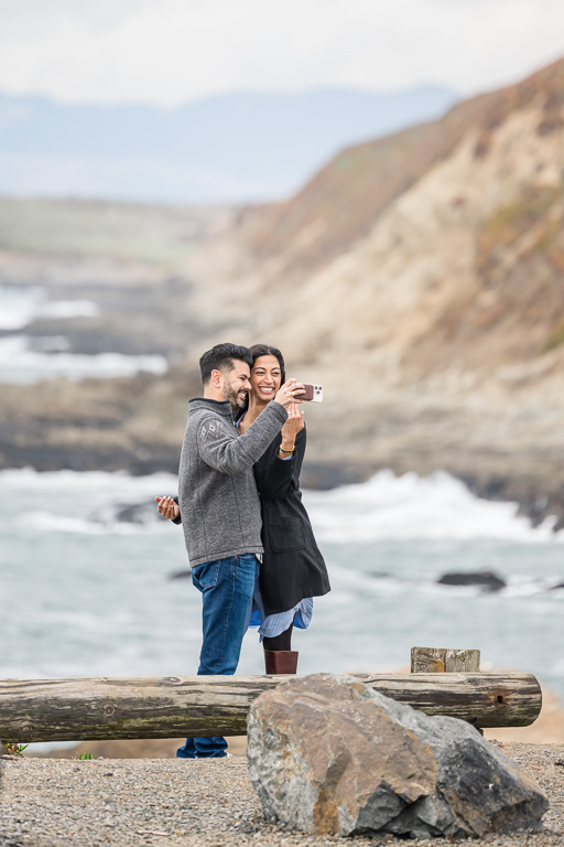 candid photo of couple showing off engagement ring after proposal