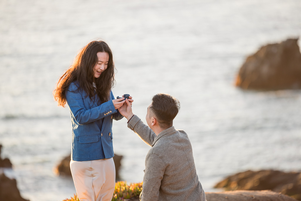 golden hour sunset proposal on cliffs over the ocean