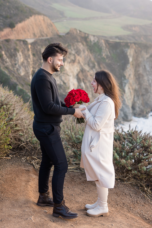 couple holding hands at the Bixby Bridge