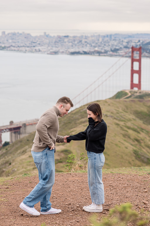 getting down on one knee to propose in front of the Golden Gate Bridge