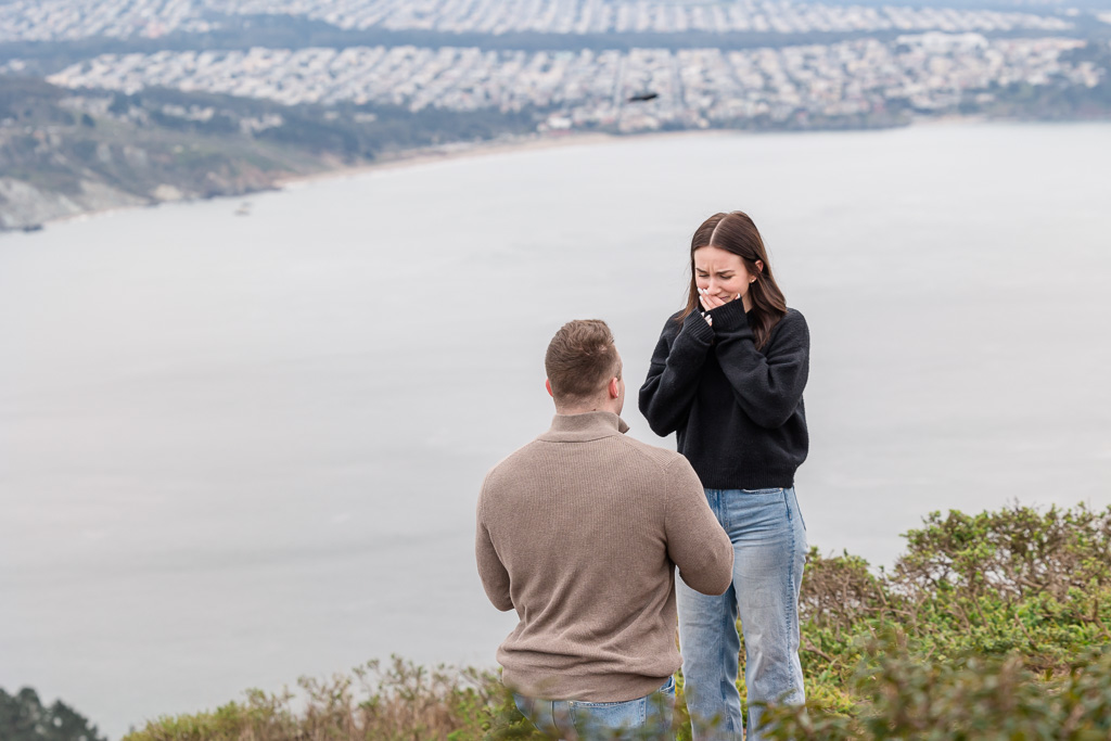 close-up reaction shot of emotional surprise proposal by photographer hidden in a bush