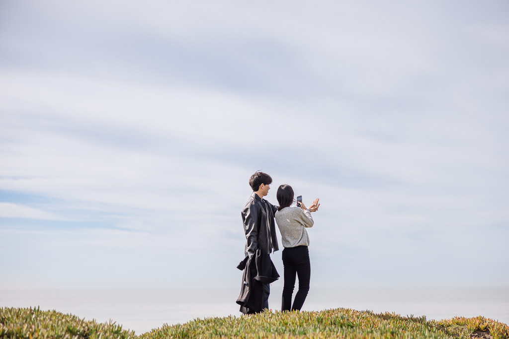 sneaky photo of couple taking photo of the ring after getting engaged