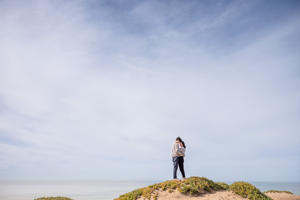 engagement photo on the sand dunes by the beach