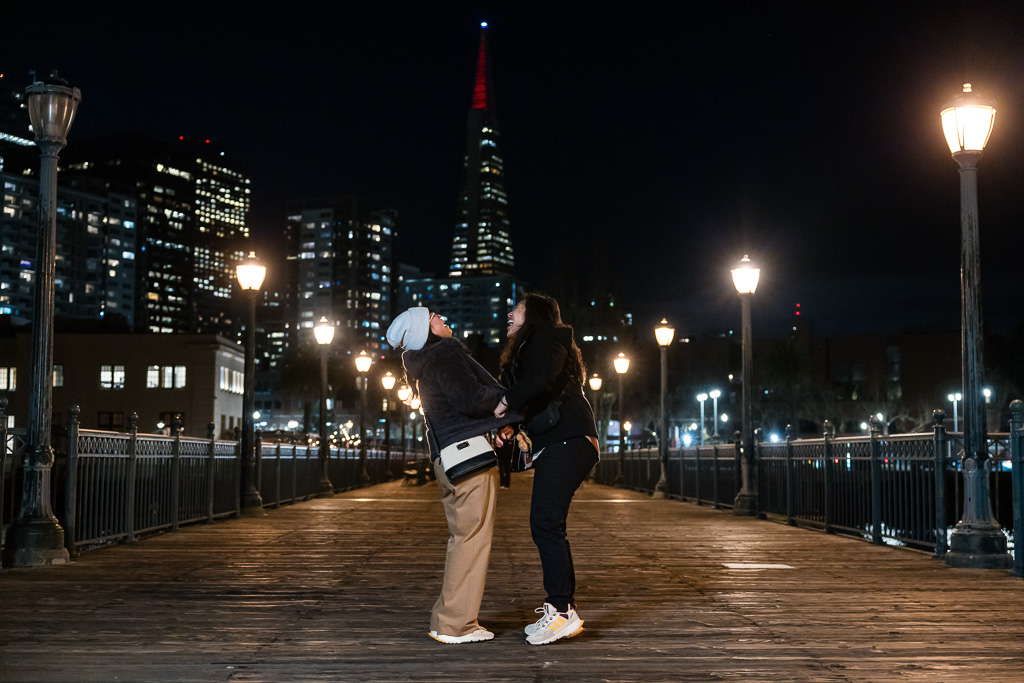 couple standing at Pier 7 laughing together