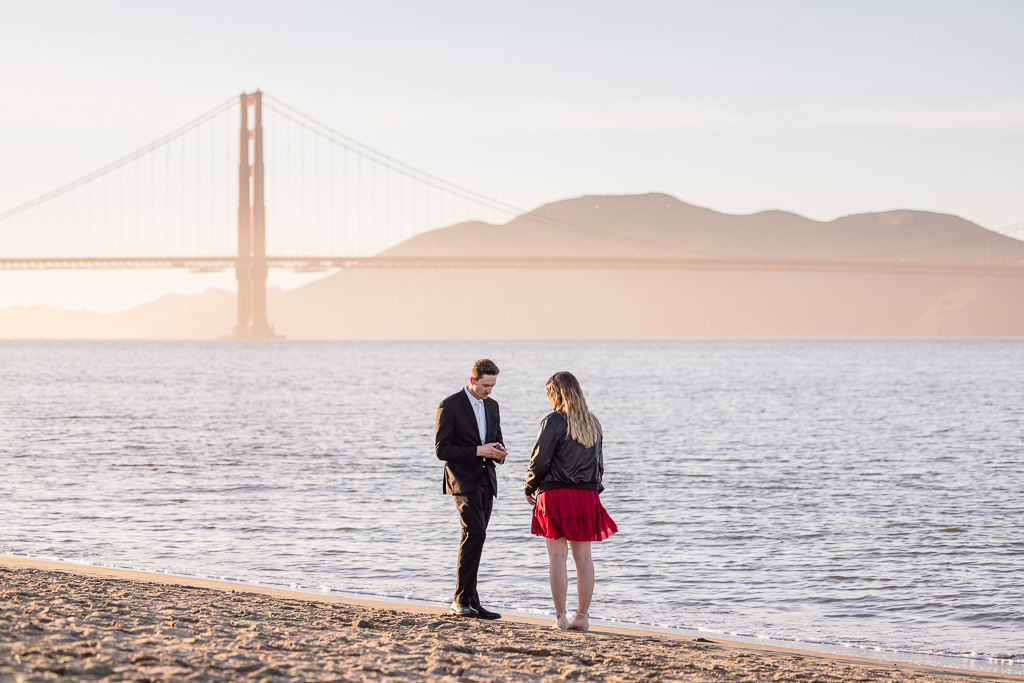 pulling out the ring for a proposal at golden hour on the Presidio beach