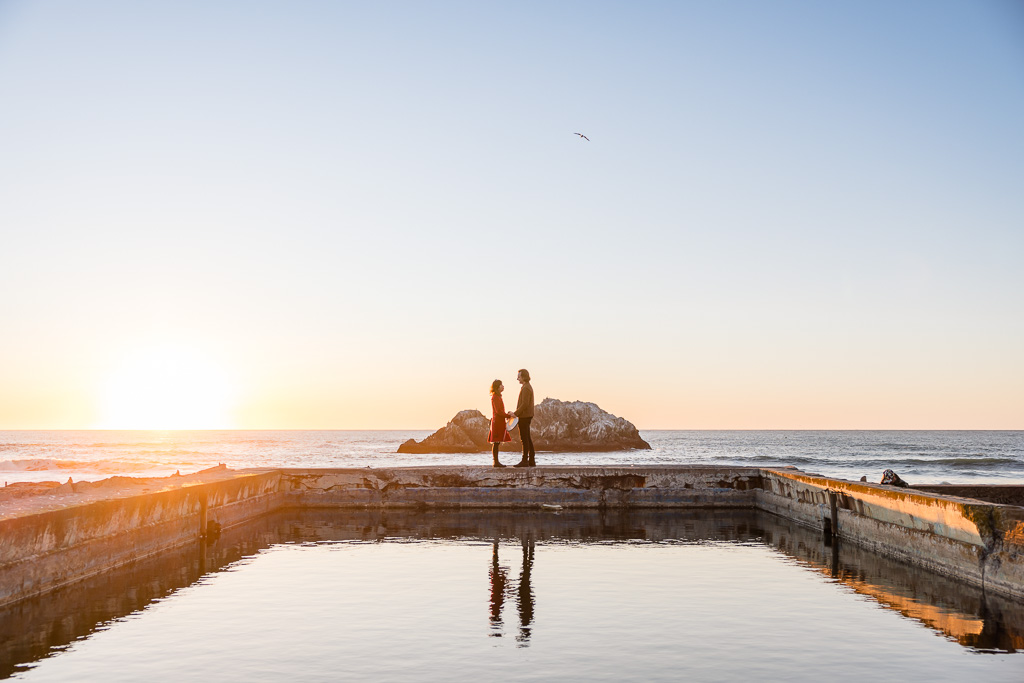 stunning silhouette of a couple against the sunset ocean sky