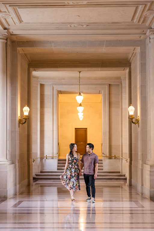 couple walking down a hallway at SF City Hall