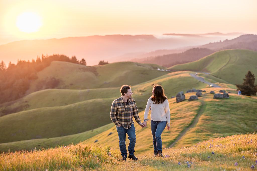 engagement photos with endless rolling hills and mountains in the background at sunset
