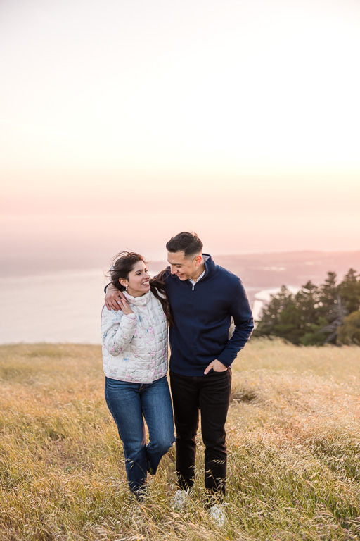 natural looking engagement photos on hillside during golden hour