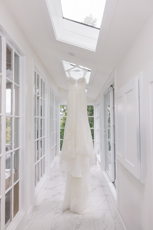wedding dress hanging in white Airbnb