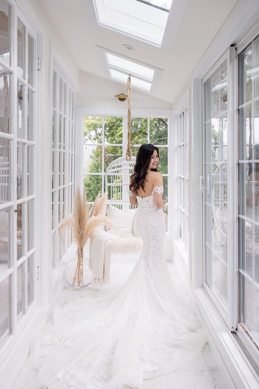 back shot of bride and her dress at a beautiful bright Airbnb