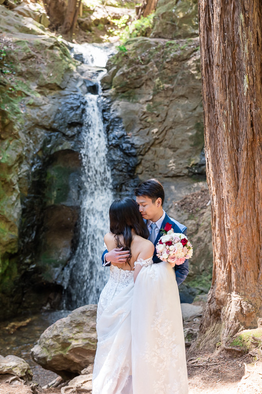 a candid emotional moment at Cascade Falls between the bride and groom