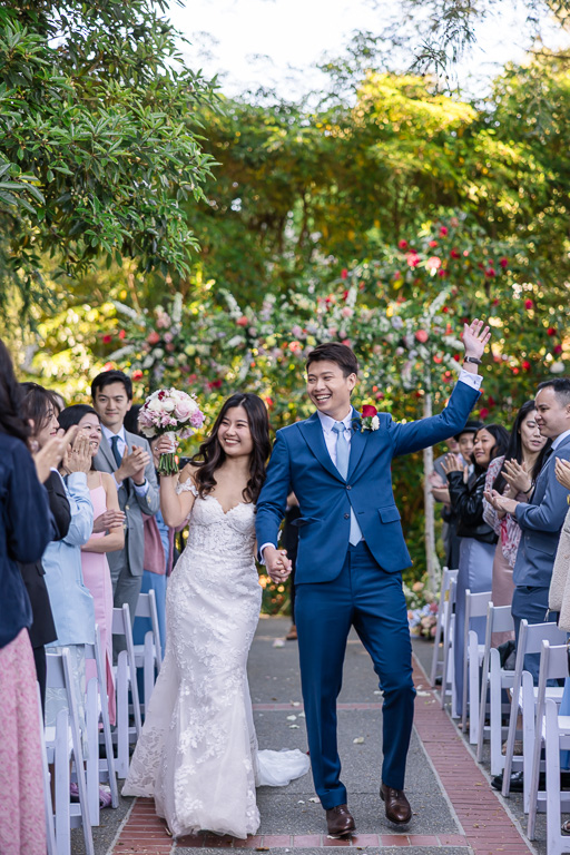 bride and groom dancing their way back up the aisle after ceremony