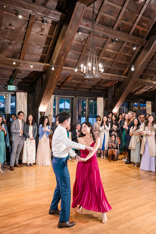 guests watching bride and groom having their dance
