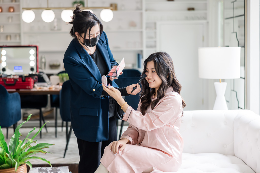 bride having makeup touchups done at an Airbnb