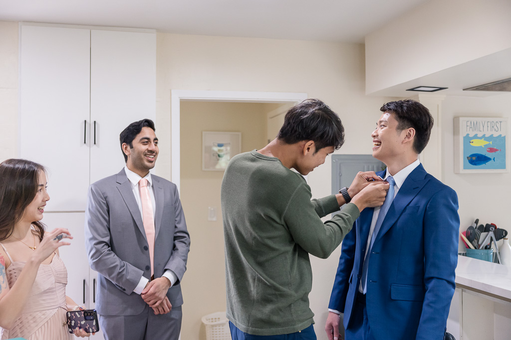 groom getting buttoned up