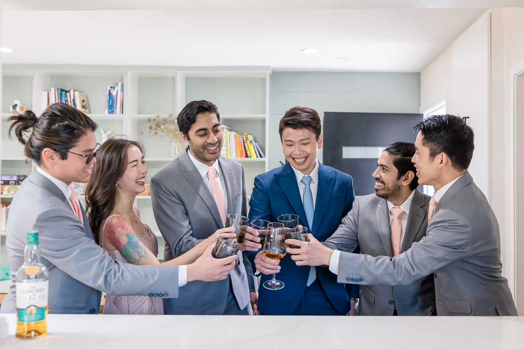 groom and groomsmen having a drink together before wedding