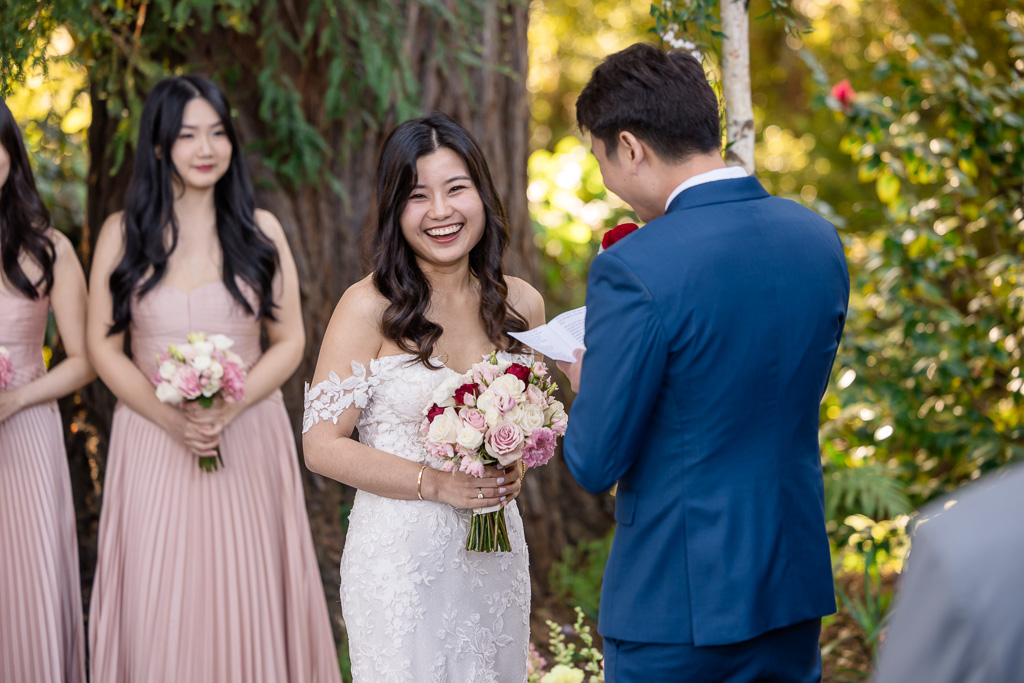 bride laughing at a funny moment in groom's wedding vows