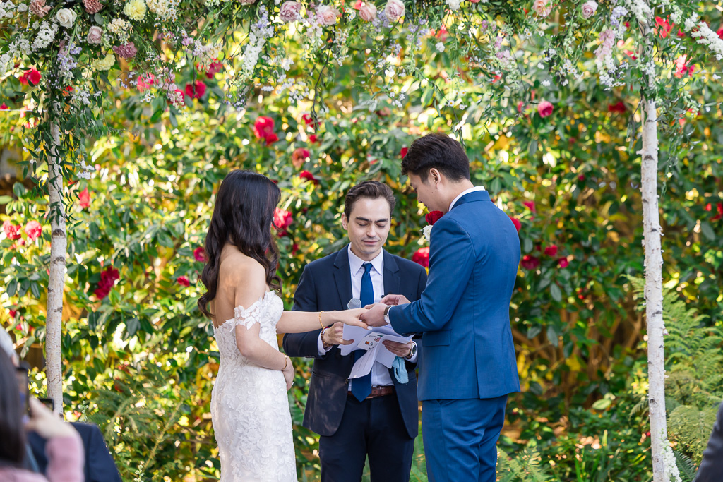 putting on the rings at an Outdoor Art Club wedding outdoor garden ceremony
