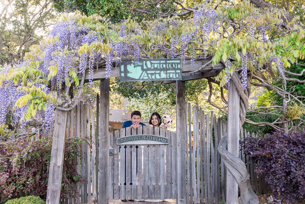Cute photo of bride and groom peeking over the Outdoor Art Club wooden gate