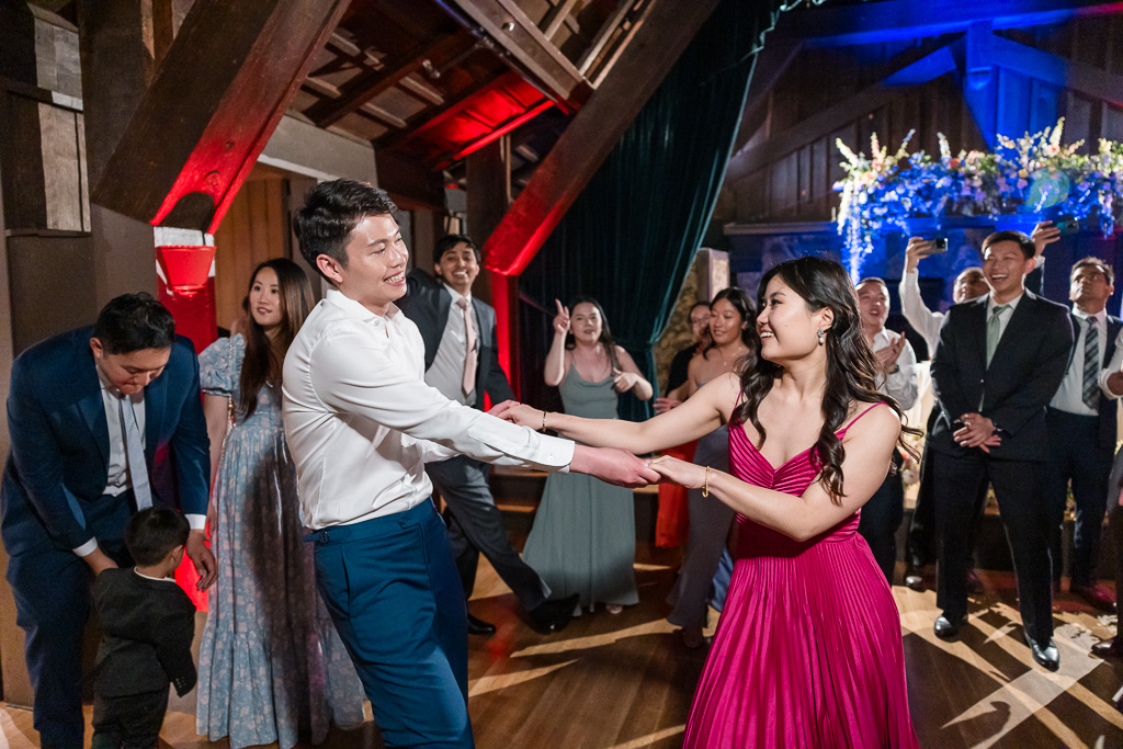 bride dragging the groom into the dance floor