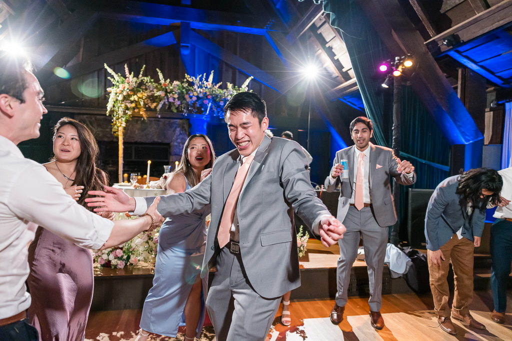 one of the groomsmen dancing and showing off