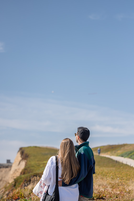 couple looking up at the sky at the airplane banner