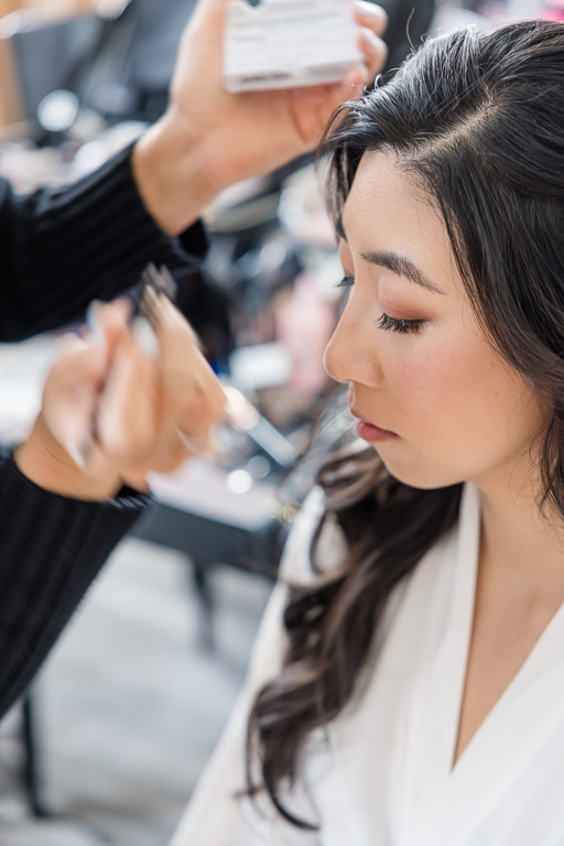 closeup of bride getting eyelashes done