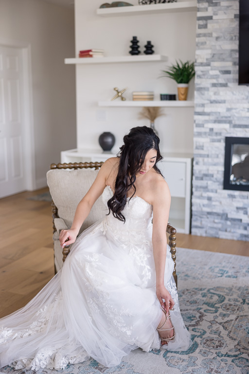 bride elegantly putting her shoes on