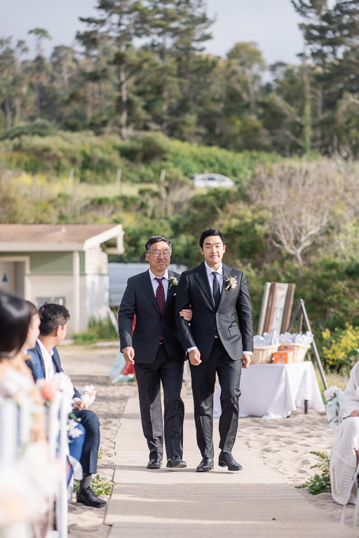 groom walking with dad up the wedding aisle