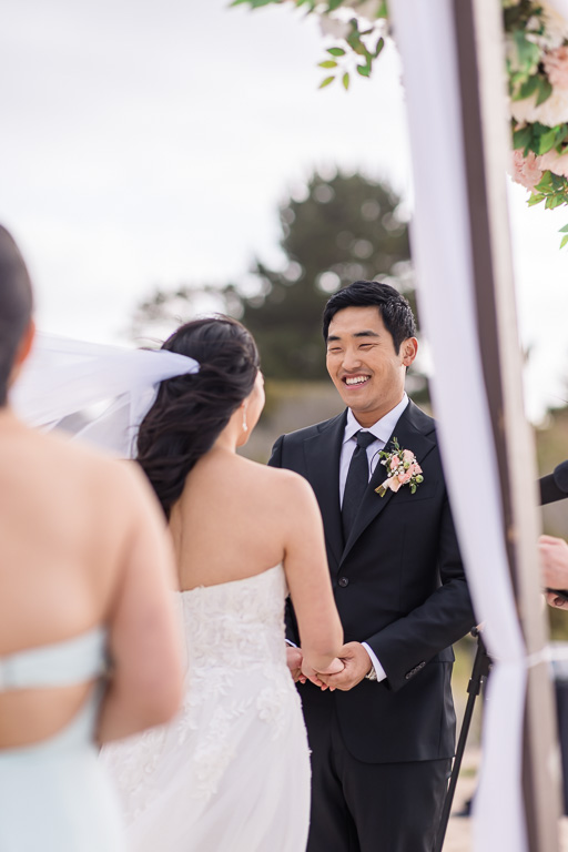 groom during ceremony on the beach