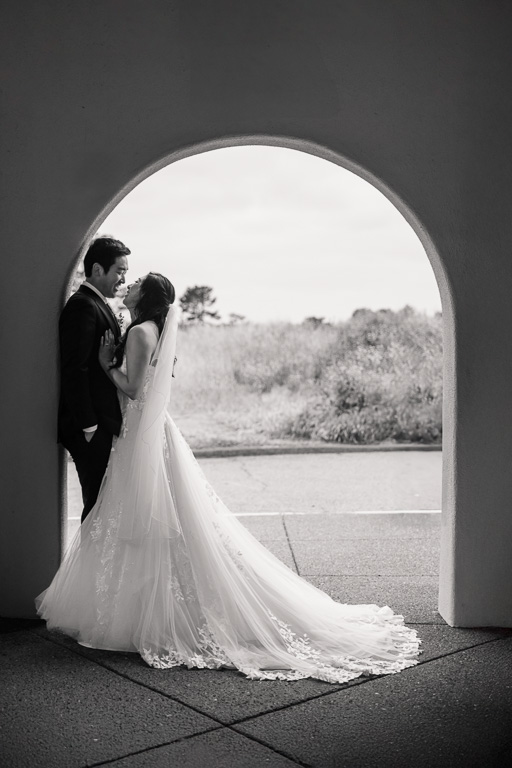 bride and groom under the archway at Carmel Fields