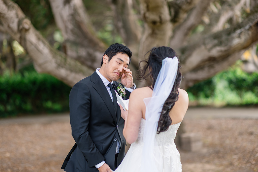 emotional moment during first look as groom wipes away a tear