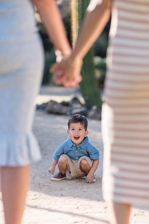 little kid looking up at his moms