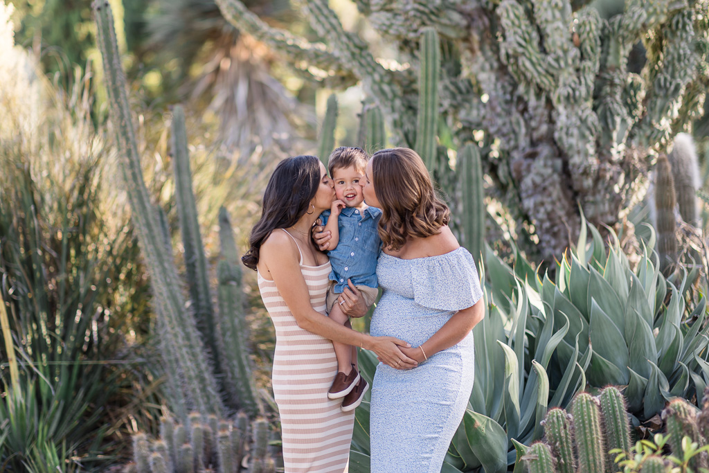 adorable photo of son being kissed by his two moms
