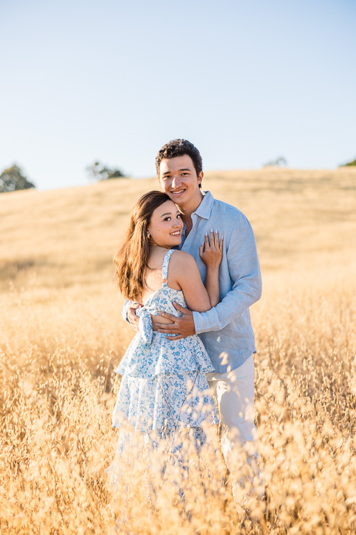engagement photo session at sunset in rolling hills of golden grass
