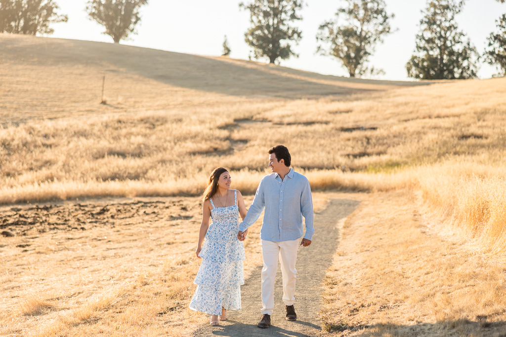 couple casually walking along a trail at golden hour