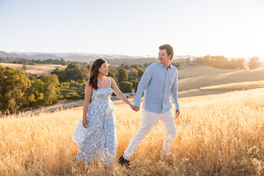 couple engagement photos in golden rolling hills at sunset