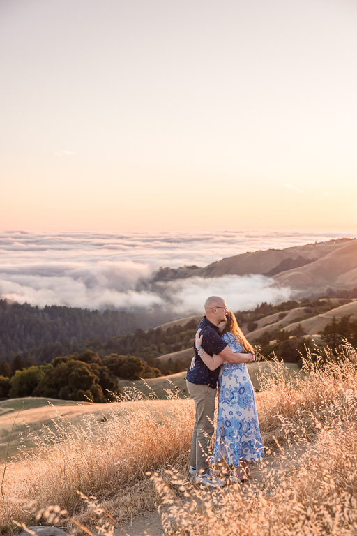 engagement photos over foggy hills below