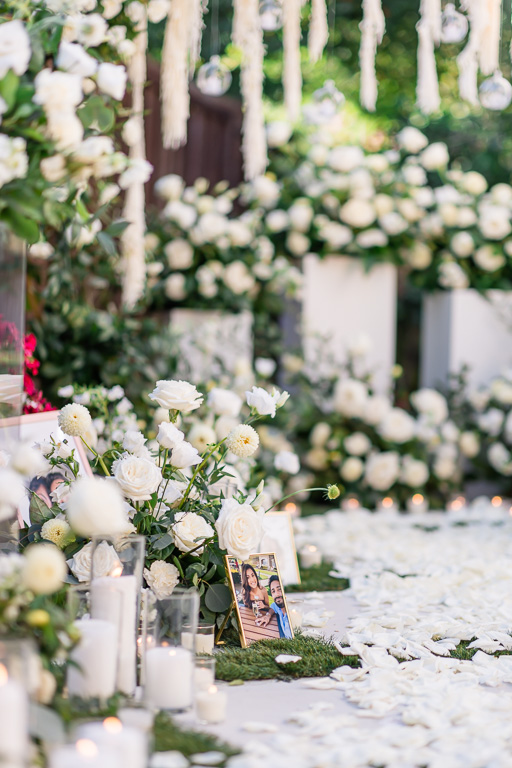 flowers, candles, and personal photos lining the walkway for marriage proposal