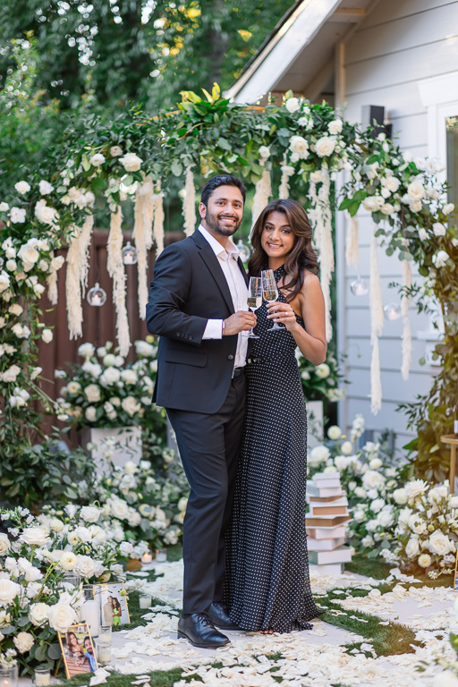 newly engaged couple holding champagne glasses