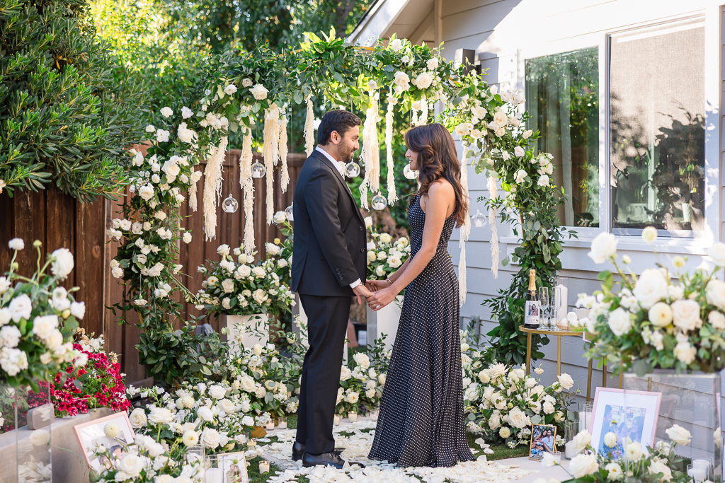 backyard surprise proposal with lush extravagant floral decor and setup